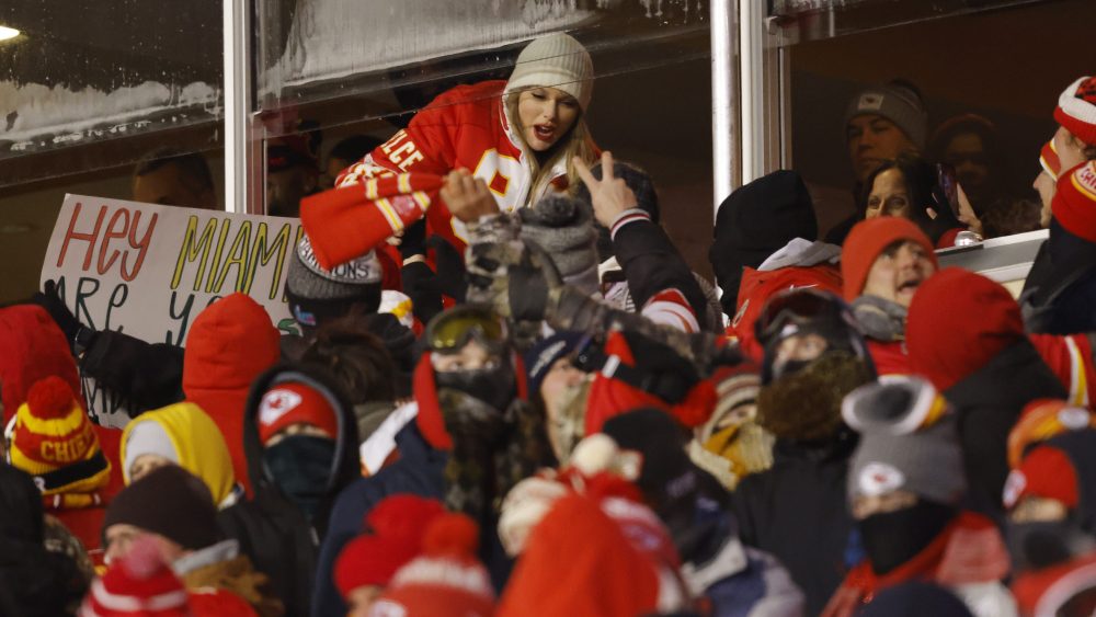 KANSAS CITY, MISSOURI - JANUARY 13: Taylor Swift celebrates with fans during the AFC Wild Card Playoffs between the Miami Dolphins and the Kansas City Chiefs at GEHA Field at Arrowhead Stadium on January 13, 2024 in Kansas City, Missouri. (Photo by David Eulitt/Getty Images)